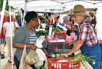  ?? CONTRIBUTE­D BY BILL MAHAN ?? The Suwanee Farmers Market gathers in Town Center Park all year long with weekly markets May into October and monthly markets the rest of the year.