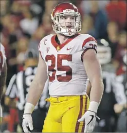  ?? Young Kwak Associated Press ?? CAMERON SMITH stands 20-plus pounds heavier during the Trojans’ game against Washington State last year. He’s a team captain for a second season.