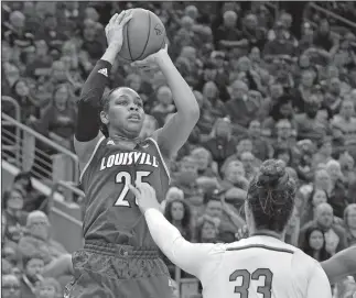  ?? TIMOTHY D. EASLEY/AP PHOTO ?? Louisville guard Asia Durr (25) shoots over Notre Dame forward Kathryn Westbeld (33) during the second half of Thursday’s game at Louisville, Ky. Louisville won 100-67.