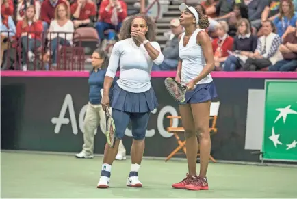  ?? SUSAN MULLANE/USA TODAY SPORTS ?? Serena Williams, left, and Venus Williams discuss strategy during the Fed Cup in Asheville, N.C.