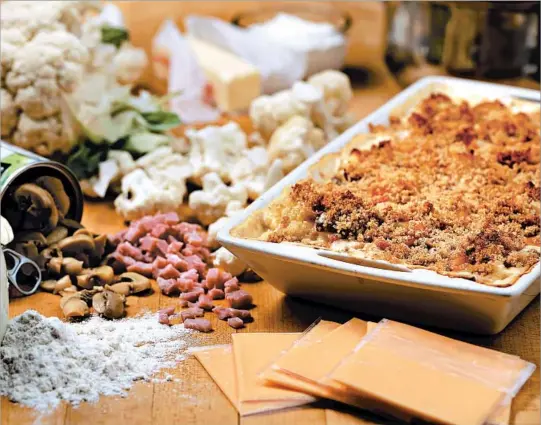  ?? E. JASON WAMBSGANS/CHICAGO TRIBUNE; MARK GRAHAM/FOOD STYLING ?? The cauliflowe­r casserole, dubbed Company Casserole on the original recipe card from Grandma, called for Old English cheese slices and canned mushrooms.