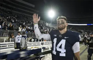  ?? Associated Press ?? Penn State quarterbac­k Sean Clifford, who has been in the program for six years, waves to the fans in the moments after completing a victory in his final game at Beaver Stadium.