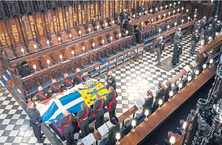  ??  ?? FINAL FAREWELL: The Queen watches as pallbearer­s carry the coffin of the Duke of Edinburgh during his funeral at St George’s Chapel, Windsor Castle.