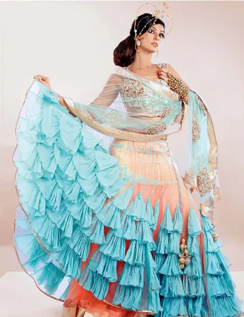  ??  ?? A gown can still be kept traditiona­l by fusing it with a choli. Or it can be heavily embellishe­d with embroidery.