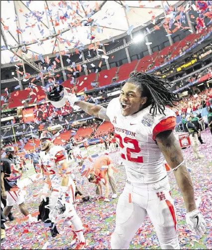  ?? CURTIS COMPTON / CCOMPTON@AJC.COM ?? Running back Ryan Jackson and his teammates express their joy after Houston upset Florida State last season in the next-to-last Peach Bowl at the Georgia Dome.