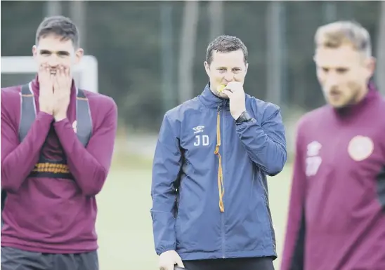  ??  ?? 2 Hearts coach Jon Daly supervises training on a day when Craig Levein, below, takes a back seat, the head coach being happy to delegate the training programme to his various lieutenant­s during the early part of the week.