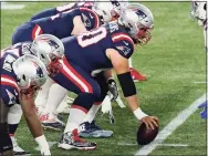  ?? Elise Amendola / Associated Press ?? New England Patriots center David Andrews prepares to snap the ball at the line of scrimmage in the first half against the Buffalo Bills in Foxborough, Mass., in December.