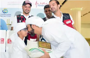  ?? Photos by Shihab ?? Six-year-old Saif, a volunteer, hands out packages to the first batch of UAE pilgrims leaving from Dubai Internatio­nal Airport to perform the Haj in Saudi Arabia on Monday. —