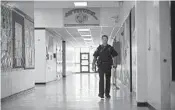  ?? SUN SENTINEL ?? Coral Springs Police Officer Van Faircloth patrols the halls and watches over students at Ramblewood Middle School in late 2012, shortly after the Sandy Hook tragedy.