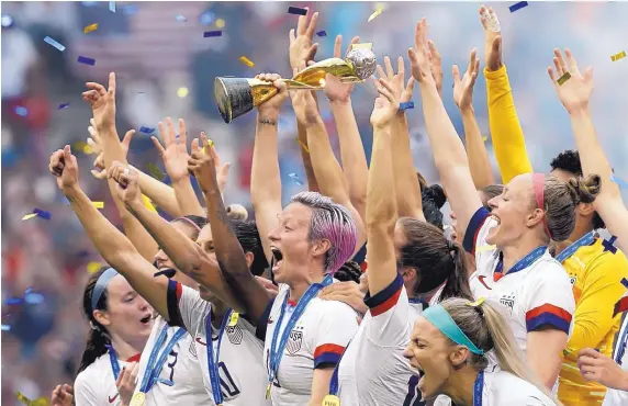  ?? CLAUDE PARIS/ASSOCIATED PRESS ?? United States’ Megan Rapinoe holds the trophy after the U.S. Women’s National Team won the World Cup against The Netherland­s, 2-0, on Sunday in France.