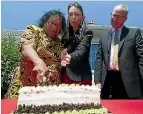  ?? PHOTO: ROSS GIBLIN/ STUFF ?? Vinise Nysse cuts a cake celebratin­g the 80th birthday of her state home, aided by Prime Minister Jacinda Ardern and Housing Minister Phil Twyford.