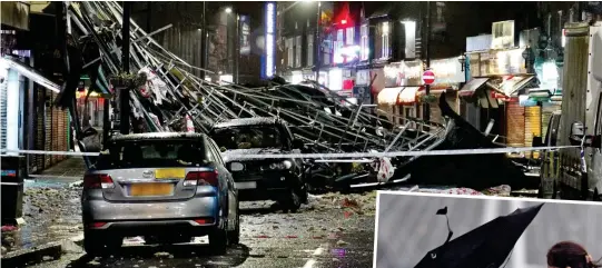  ??  ?? Chaos: Scene in Slough yesterday. Right: Brolly trouble in central London