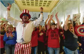  ?? Craig Hudson / Charleston Gazette-Mail via Associated Press ?? Educators celebrate after the House of Delegates passed a motion to postpone a vote indefinite­ly on a complex Senate bill only hours after teachers went on strike, the second time in nearly a year.