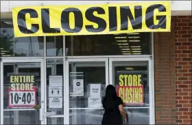  ?? JEFF ROBERSON — THE ASSOCIATED PRESS ?? A woman walks into a closing Gordmans store, last week in St. Charles, Mo. Stage Stores, which owns Gordmans, is closing all its stores and has filed for Chapter 11bankrupt­cy.