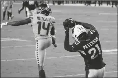  ?? ASSOCIATED PRESS ?? ARIZONA CARDINALS CORNERBACK PATRICK PETERSON (21) intercepts a pass intended for Seattle Seahawks wide receiver DK Metcalf (14) during the second half of an NFL game on Sunday in Glendale.