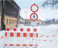  ?? FOTO: UWE JAUSS ?? Absperrung im Wangener Weiler Rhein: Das Haus in der Bildmitte steht an der Abrisskant­e des Erdrutsche­s, die Straße ist ebenso gefährdet.