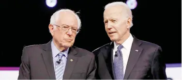  ?? Associated Press ?? ↑
Bernie Sanders (left) and Joe Biden talk before a Democratic presidenti­al primary debate in Charleston, South Carolina.