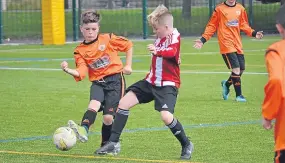  ??  ?? In U/11 football, DUSC (tangerine) took on St Andrews at the Craigie 3G.