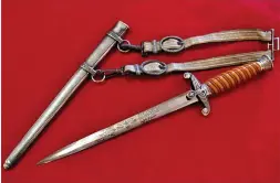  ??  ?? This early model Heer dagger has silver plated hilt fittings and scabbard. The purchaser spared no expense as the beautifull­y engraved blade is a statement in itself ( JB Military Antiques)
