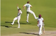  ?? Photo: AP ?? Australia players celebrate the wicket of Shamarh Brooks.