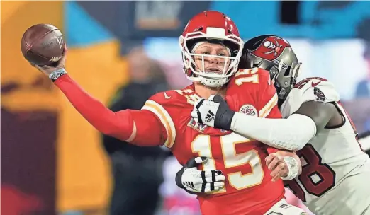  ?? ASSOCIATED PRESS ?? Kansas City Chiefs quarterbac­k Patrick Mahomes passes while getting hit by Tampa Bay outside linebacker Shaquil Barrett on Sunday. Mahomes often had very little time to throw.