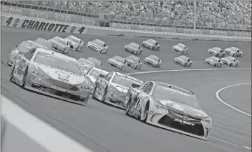  ?? Ap-chuck Burton, File ?? In this May 29, 2016, file photo, Martin Truex Jr (78) and Joey Logano (22) lead the field out of Turn 4 for the start of the NASCAR Sprint Cup series auto race at Charlotte Motor Speedway in Concord, N.C. The governor of North Carolina says NASCAR can go forward with the Coca-cola 600 at Charlotte Motor Speedway at the end of May so long as health conditions do not deteriorat­e.