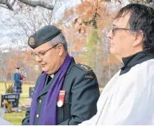  ??  ?? Chaplain Kent Greer, of 14 Wing Greenwood, and Rev. Paul Jennings, Holy Trinity Anglican Church, officiated at the ceremony Nov. 5, where MRHS students placed poppies on the headstones of Commonweal­th airmen killed in training exercises based out of Greenwood.