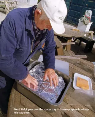  ??  ?? Next, tinfoil goes over the spacer tray — its sole purpose is to keep the tray clean