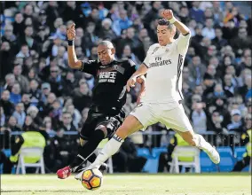  ?? Picture: GETTY IMAGES ?? ON A HIGH: Cristiano Ronaldo of Real Madrid competes for the ball against Gabriel Silva of Granada during the La Liga match between Real Madrid and Granada CF on Saturday in Madrid, Spain