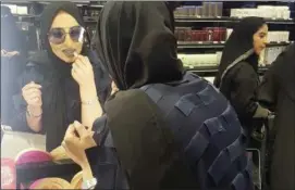  ?? AYA BATRAWY — THE ASSOCIATED PRESS ?? In this Thursday photo, Bahraini singer Jihan Sheib tries on a shade of blue lipstick from Rihanna’s new Fenty line that debuted across the kingdom in Sephora stores in Riyadh, Saudi Arabia.