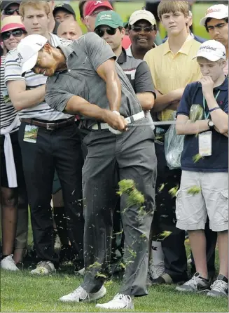 ?? Timothy A. Clary, Afp-getty Images ?? Tiger Woods often found himself in the rough on Thursday, but his putter allowed him to salvage a 72.