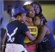  ?? MATTHEW HINTON —THE ASSOCIATED PRESS ?? People react at the scene of shooting in New Orleans, Saturday.