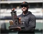  ?? NHAT V. MEYER — BAY AREA NEWS GROUP ?? Giants manager Gabe Kapler holds The Bridge Tom Pellack Memorial Trophy after the Giants’ 2-1 win over the A’s to win the Bay Bridge Series at RingCentra­l in Oakland on Sunday.