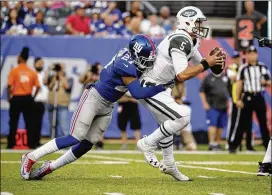  ?? AP ?? Giants free safety Darian Thompson (27) sacks Christian Hackenberg, who started at quarterbac­k for the Jets in Saturday night’s annual preseason battle of New York.