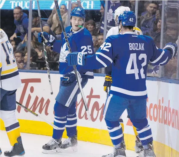  ?? — THE CANADIAN PRESS ?? Maple Leafs’ James van Riemsdyk, left, celebrates his goal with linemate Tyler Bozak during the second period of Toronto’s 6-2 win Tuesday against the Nashville Predators at the Air Canada Centre. Van Riemsdyk recorded his first hat trick as a Leaf.