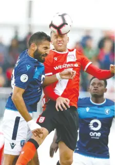  ??  ?? Cavalry FC’S Oliver Minatel gets his head on the ball while contesting FC Edmonton’s Ajay Khabra for possession on Friday night.