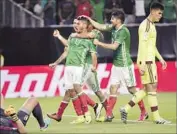  ?? David J. Phillip Associated Press ?? MEXICO’S Jesus Manuel Corona (10) celebrates his goal against Venezuela with his El Tri teammates.