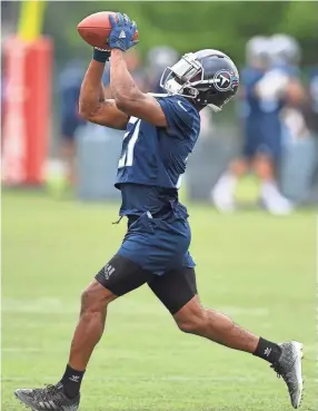  ??  ?? Titans cornerback Malcolm Butler pulls in the ball during practice in June at Saint Thomas Sports Park.