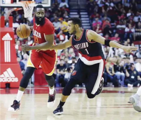  ?? — AP ?? HOUSTON: Houston Rockets guard James Harden (13) brings the ball up the court as he is defended by Portland Trail Blazers guard Evan Turner (1) in the second half of an NBA basketball game on Thursday, in Houston.