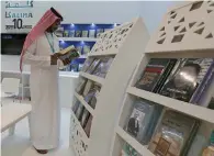  ?? Photo by Ryan Lim ?? A Kalima official checks a translated book during the Abu Dhabi Internatio­nal Book Fair. —