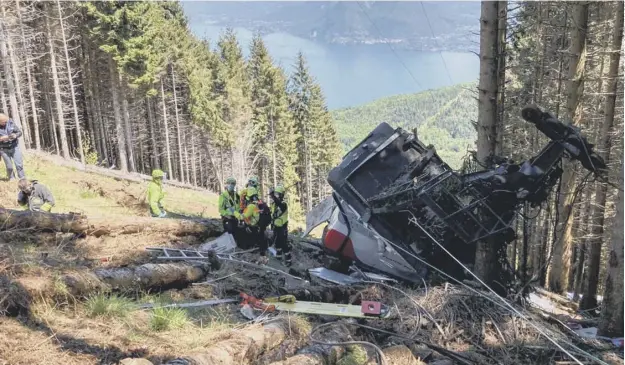  ??  ?? 0 The crash, attended by the National Alpine Rescue Corp which released this image, happened on a steep, forested mountainsi­de