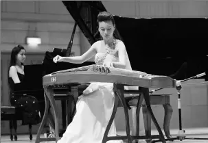  ?? PHOTOS PROVIDED ?? Left: Ji Wei holds a solo concert at Beijing’s Forbidden City Concert Hall in 2009. Above: Ji performs with her guzheng ensemble at the Beijing Concert Hall in 2013.