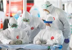  ?? Seongjoon Cho / Bloombe rg ?? Medical staff in protective gear work at a coronaviru­s testing station at Incheon Internatio­nal in South Korea.