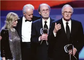  ?? Alberto E. Rodriguez / Getty Images 2009 ?? Burt Metcalfe (third from left) is joined by Loretta Swit, Mike Farrell and Alan Alda in accepting the TV Land Impact Award for “MASH” at a 2009 ceremony.