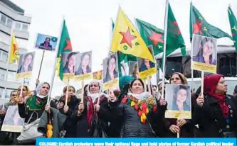  ??  ?? COLOGNE: Kurdish protesters wave their national flags and hold photos of former Kurdish political leader Hevrin Khalaf, during a pro-Kurdish demonstrat­ion in Cologne, western Germany. —AFP