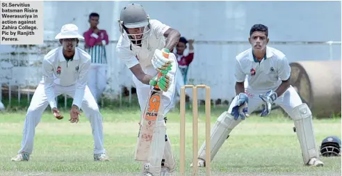  ??  ?? St.Servitius batsman Risira Weerasuriy­a in action against Zahira College. Pic by Ranjith Perera.