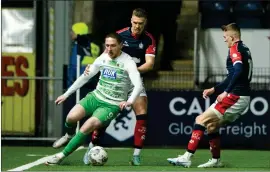  ?? ?? TNS forward Declan McManus takes on Tom Lang at the Falkirk Stadium