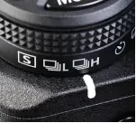  ?? ?? Dial-style function key cluster is a carry-over from Nikon’s pro DSLRs. Drive mode selector is located at the base.