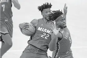  ??  ?? Miami's Jimmy Butler (22) tries to get past Oklahoma City's Luguentz Dort (5) during the Heat's 108-94 win Monday at Chesapeake Energy Arena. [BRYAN TERRY/THE OKLAHOMAN]