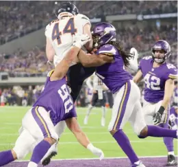  ?? GETTY IMAGES ?? Bears linebacker Nick Kwiatkoski leaps between two defenders to catch a two-point conversion pass in the fourth quarter Sunday against the Vikings.